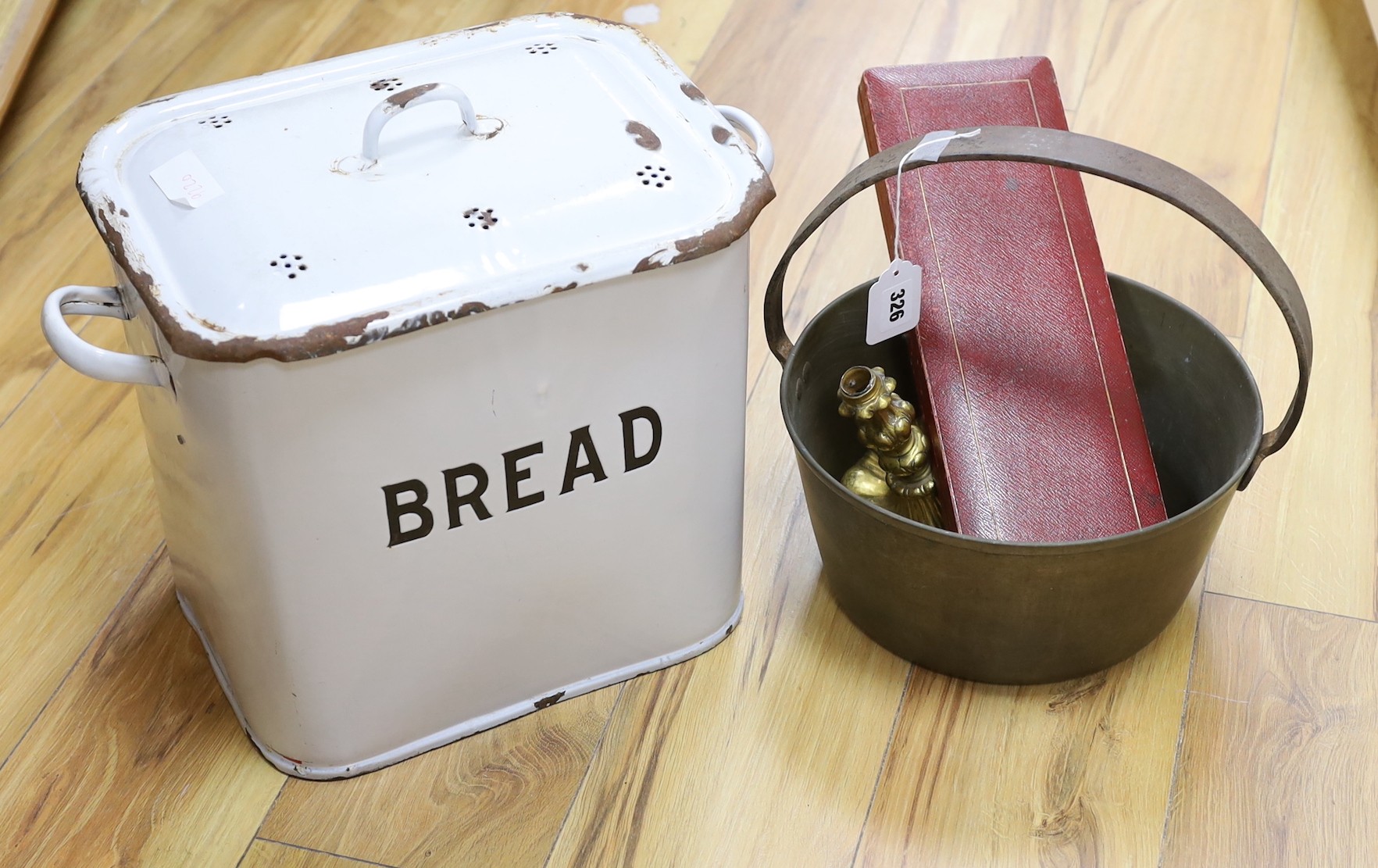 A brass cooking pot, a gilt metal candlestick, an enamel bread bin and cased fish servers